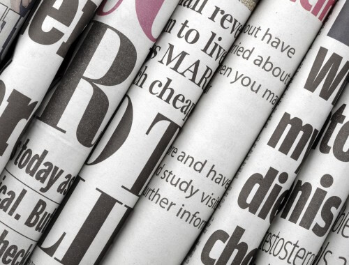 close up of newspapers to represent Trueform's news section.