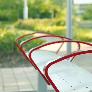 close up of public seating in gullwing bus shelter.