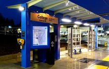 waiting shelter with a covered canopy over ticket machine.