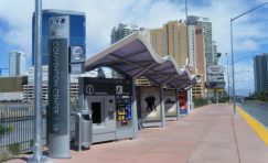 Custom designed transit bus shelter next to a road.