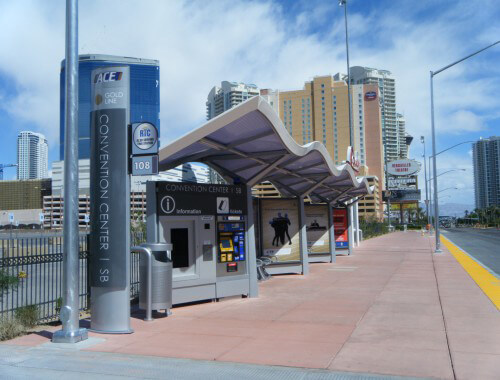 Custom designed transit bus shelter next to a road.