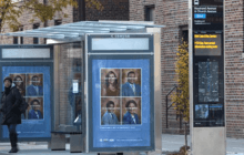 Double sided LED SBS wayfinding totem in with real-time passenger information next to a bus stop.