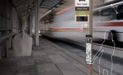 smart bus stop sign with white silhouette of a person using it.